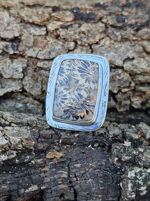  adjustable sterling silver ring showcases ancient 20-million-year-old Indonesian fossilized coral with a striking stingray pattern. Fits sizes 7-10.