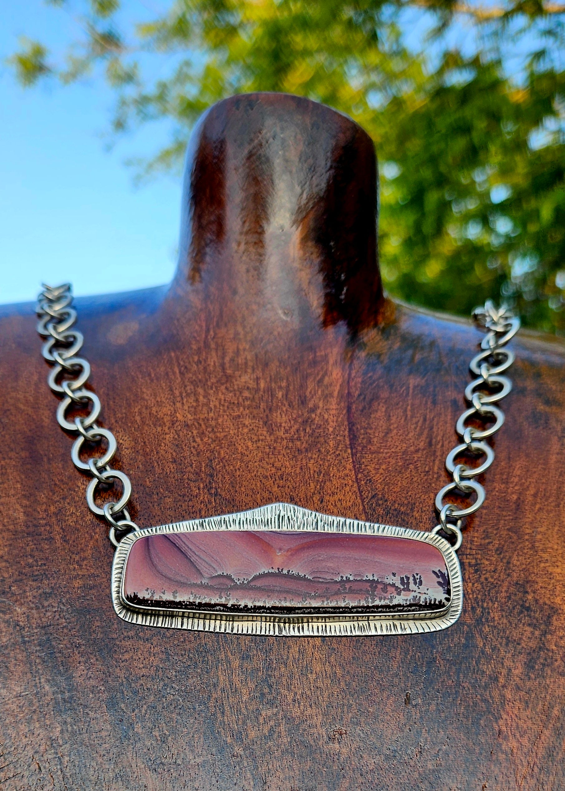 Rectangular Apache Sage rhyolite pendant set in sterling silver with an 16 inch handmade chain. Pink desert sunset scene.