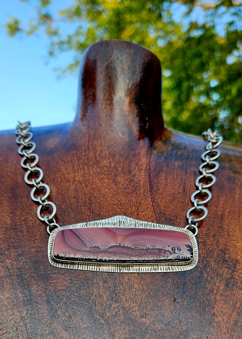 Rectangular Apache Sage rhyolite pendant set in sterling silver with an 16 inch handmade chain. Pink desert sunset scene.
