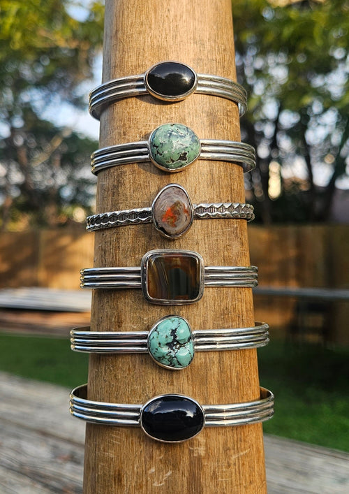 Sterling silver bracelet with black onyx, turquoise, opal, and agate.
