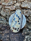 Dalmatian Jasper Ring set in sterling silver with a circular textured backplate. Size 7