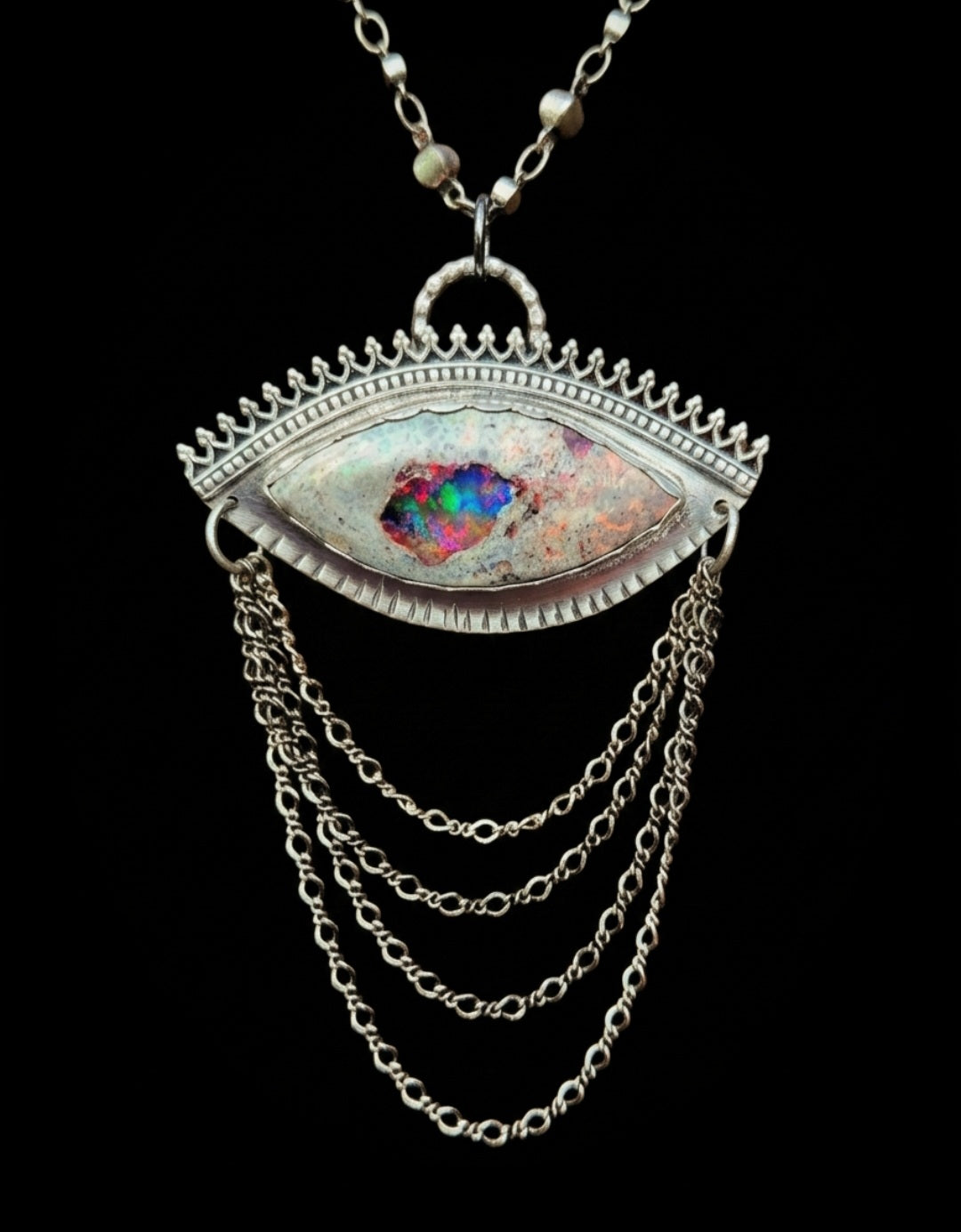 Sterling silver eye pendant with mexican matrix opal and cascading silver chains.