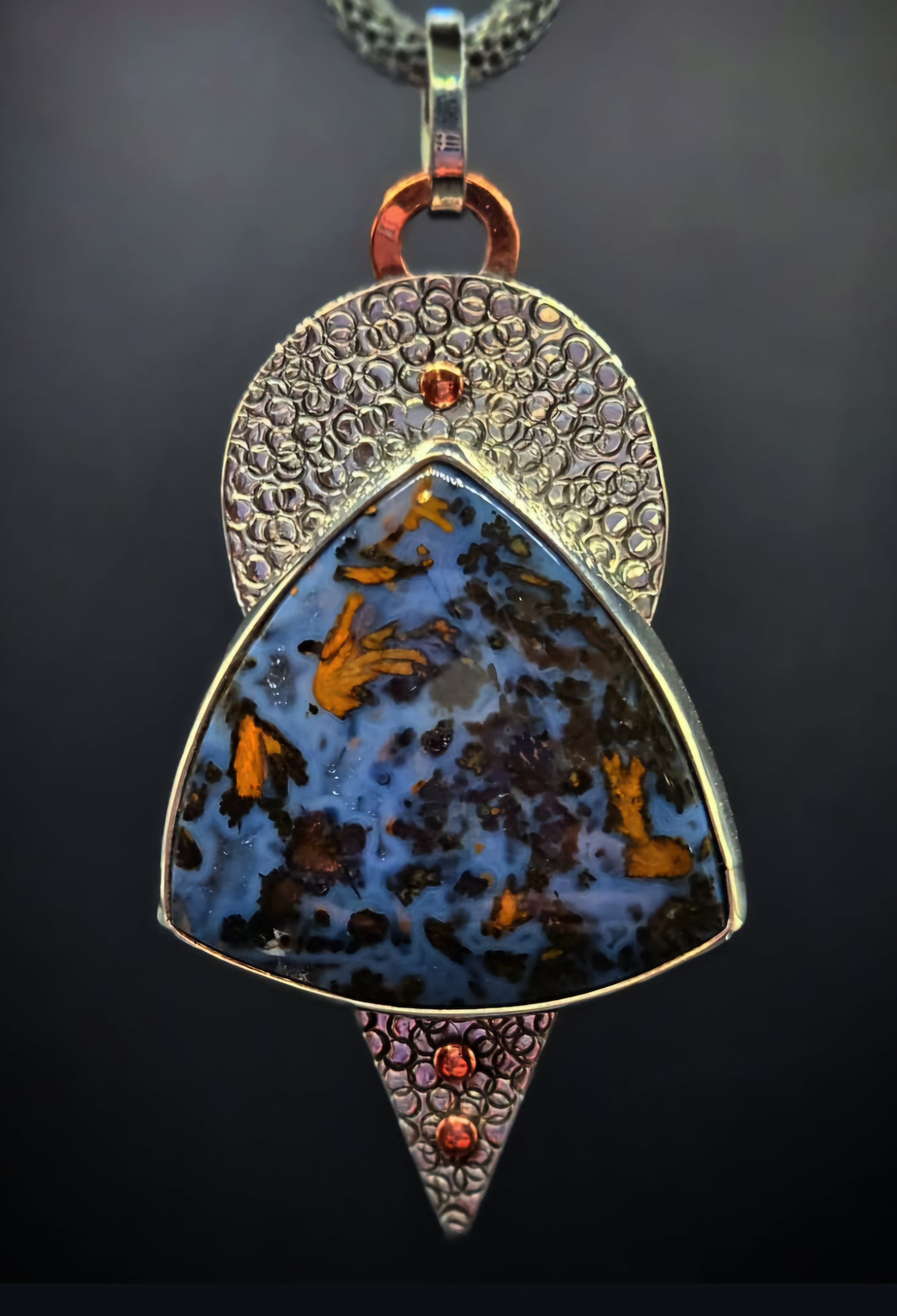 Large blue and copper colored Pietersite pendant set in sterling silver. Hand textured backplate with copper accents 