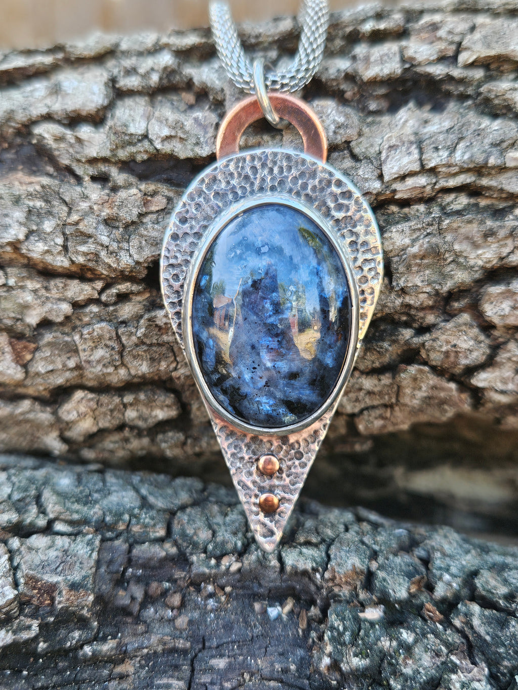 Blue and Black larvakite pendant set in sterling silver with a textured backplate and copper accents.