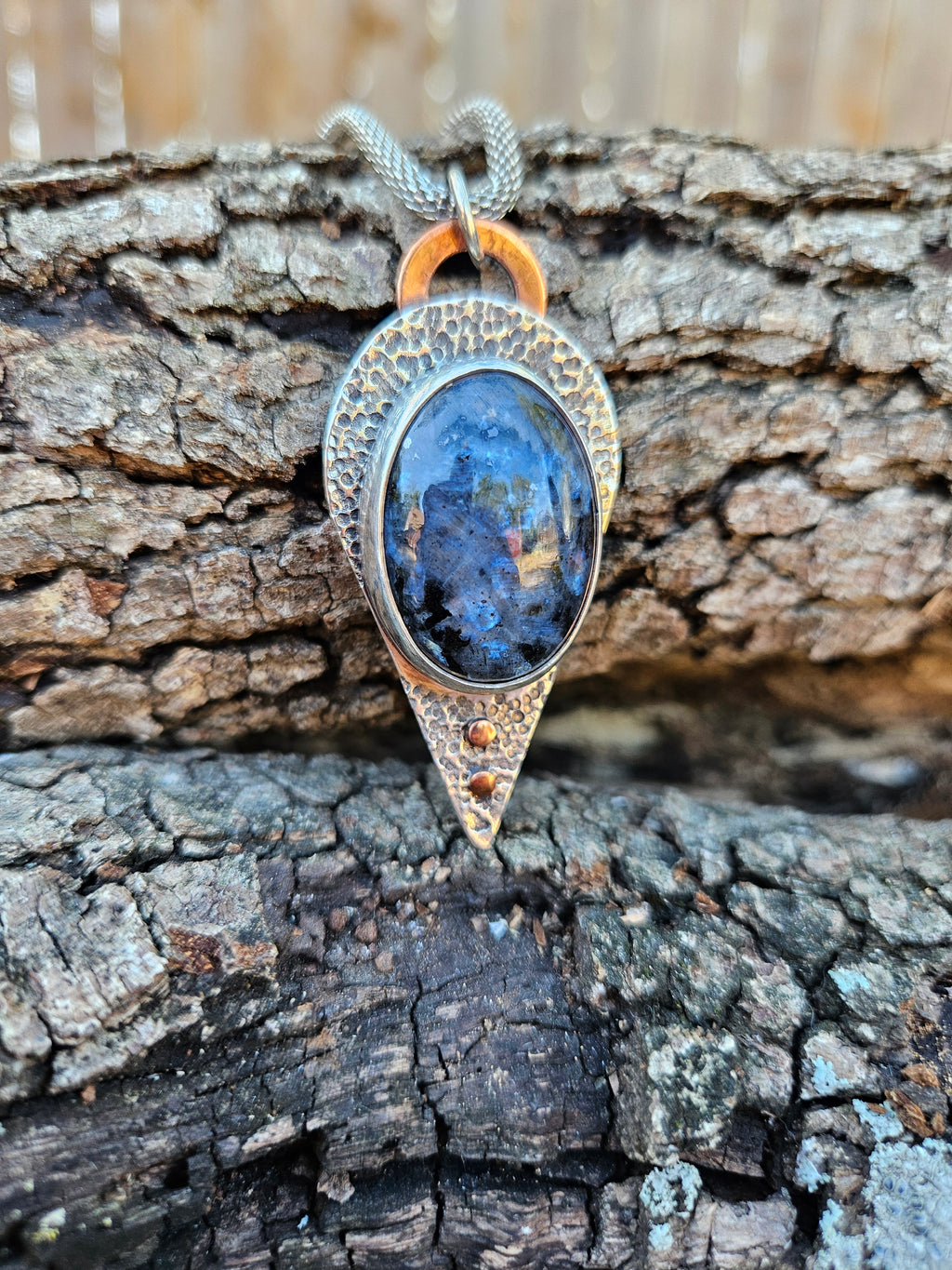 Blue and Black larvakite pendant set in sterling silver with a textured backplate and copper accents.