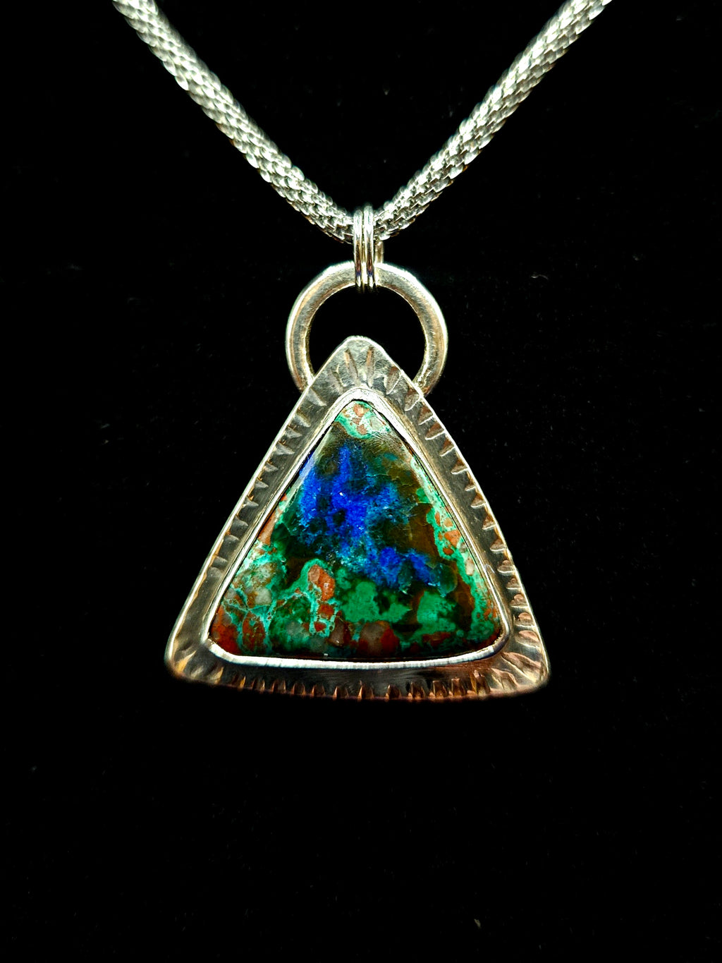 Triangular shaped Malachite Azurite Pendant set in sterling silver with a textured border. Green and blue colors.