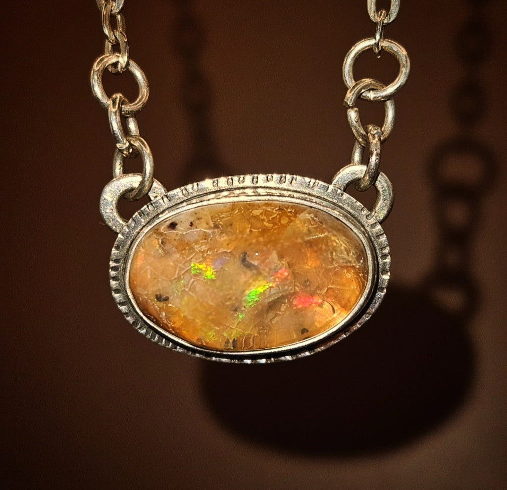 Oval shaped Mexican Fire Opal set in sterling silver 