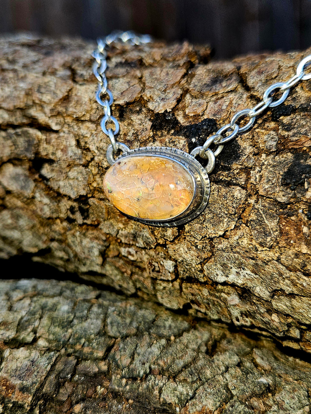 Oval shaped Mexican Fire Opal set in sterling silver 