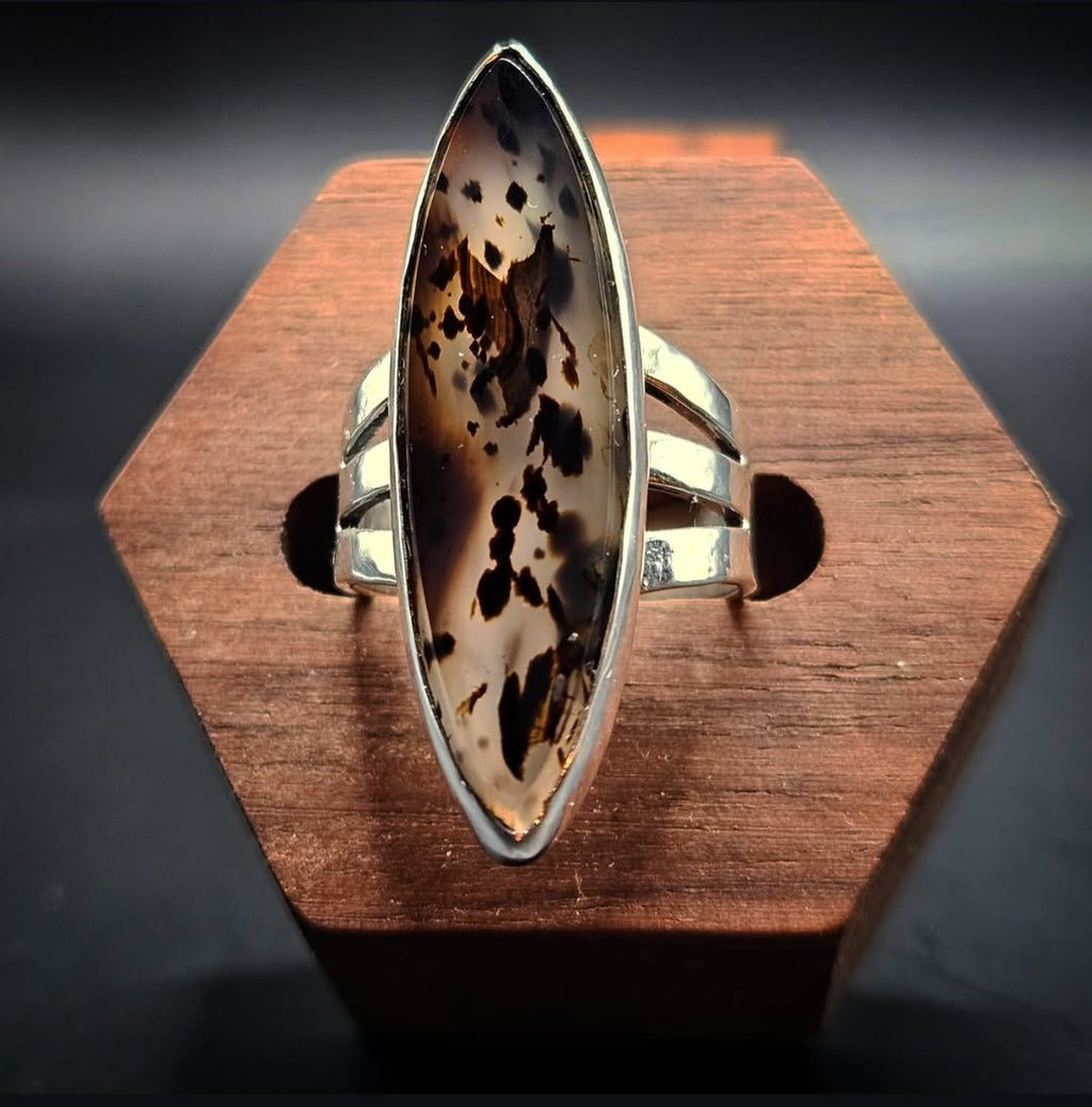 Marquise shaped Montana Moss Agate Ring set in sterling silver with a 3 band setting. Clear and black. Size 6.5