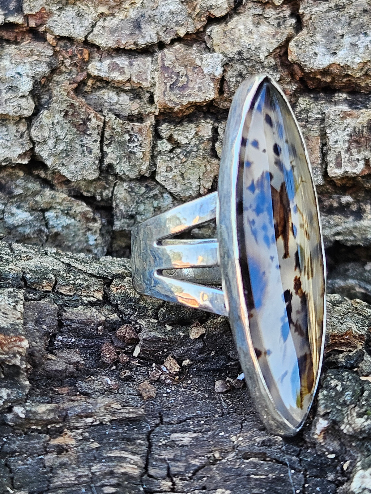Marquise shaped Montana Moss Agate Ring set in sterling silver with a 3 band setting. Clear and black. Size 6.5
