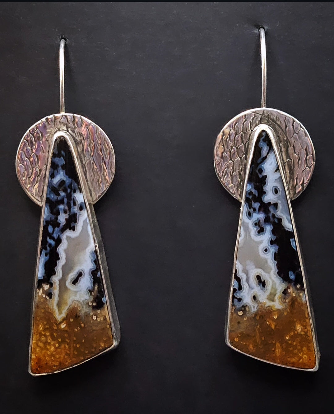 Triangular Shaped Petrified Palm Wood Earrings set in sterling silver with a textured circular backplate. Dangle earrings. Multi color, black, white, and amber.