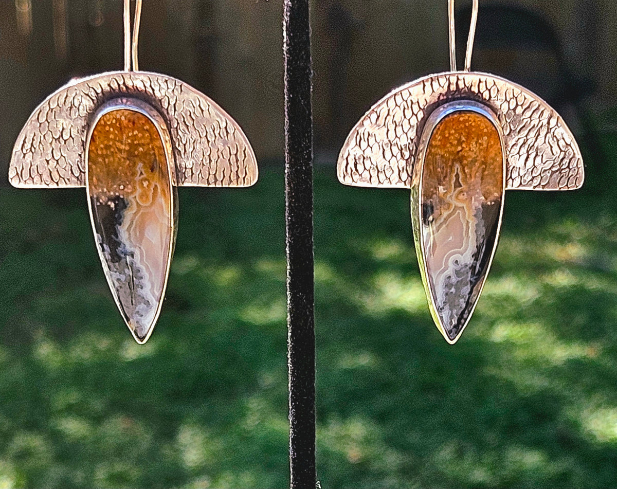 Geometric half moon textured silver earrings with teardrop petrified palm wood. Black white and yellow colors.