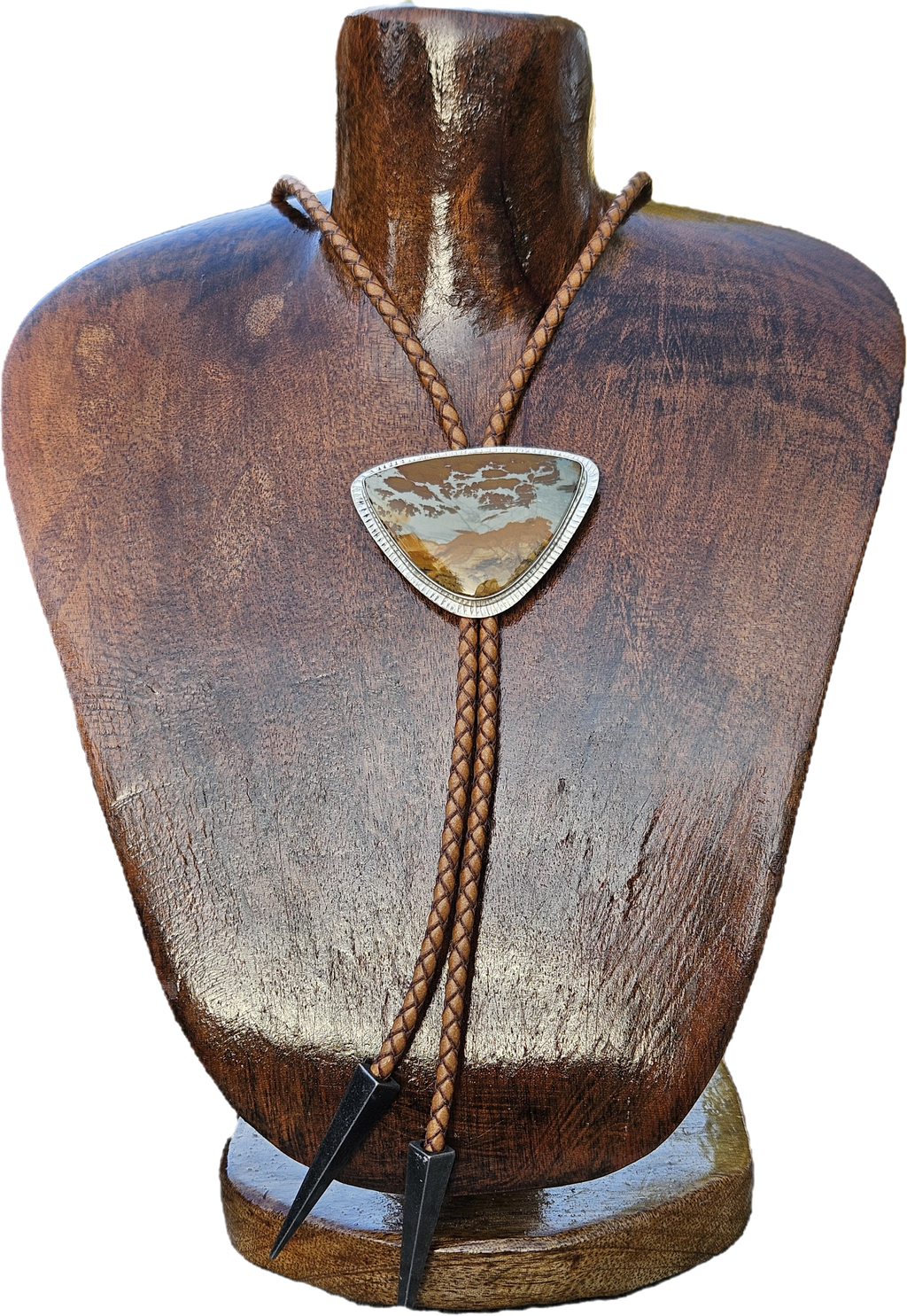 Owyhee Blue Sky Picture Jasper Bolo set in sterling silver with a textured border on a light brown leather cord with triangular antique silver tips