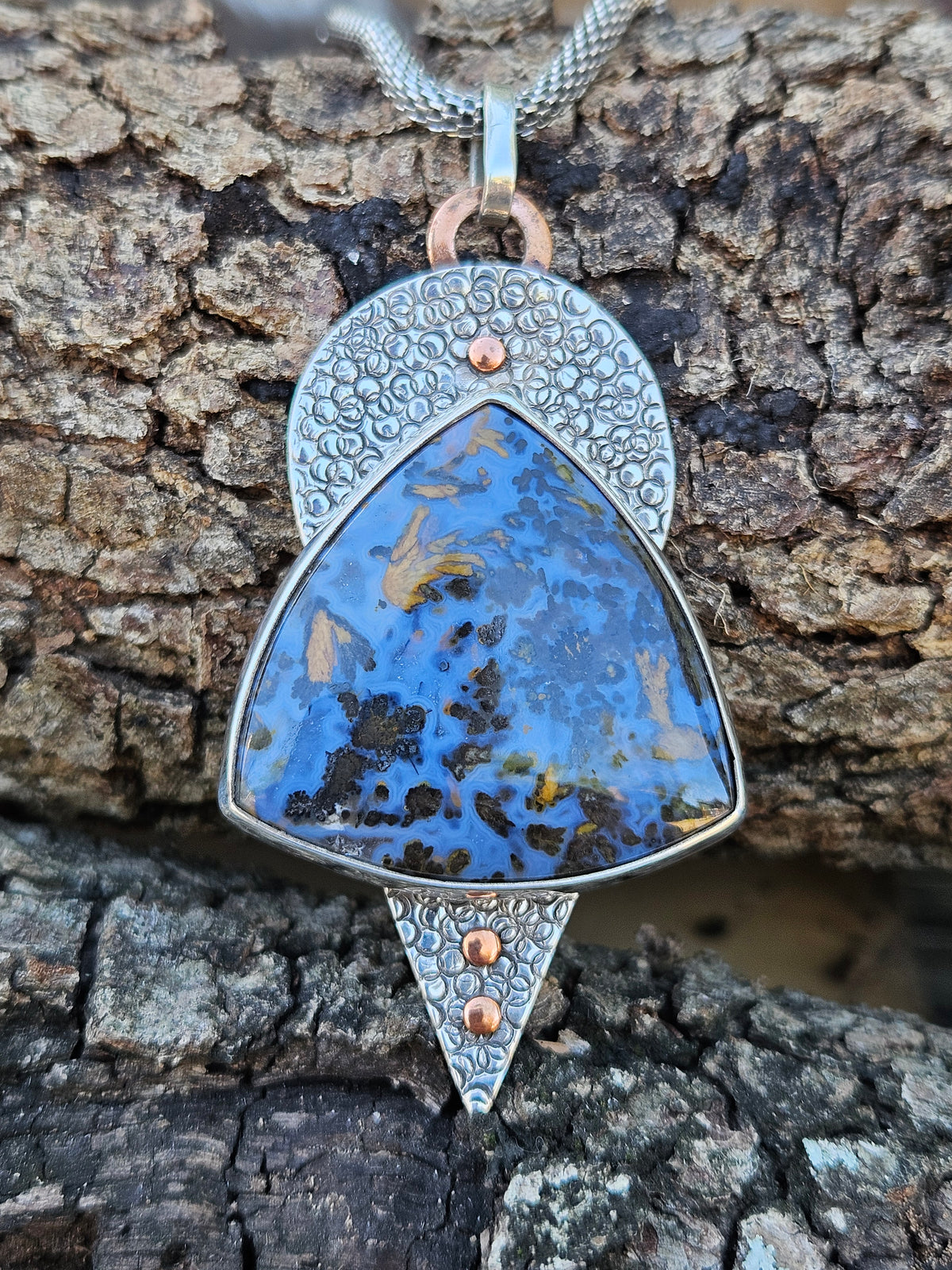 Large blue and copper colored Pietersite pendant set in sterling silver. Hand textured backplate with copper accents 