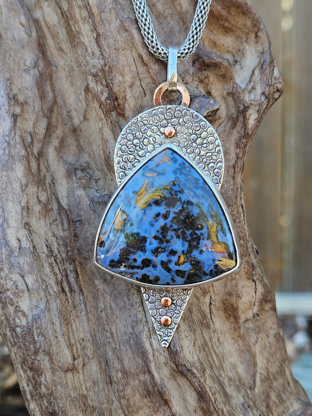 Large blue and copper colored Pietersite pendant set in sterling silver. Hand textured backplate with copper accents 