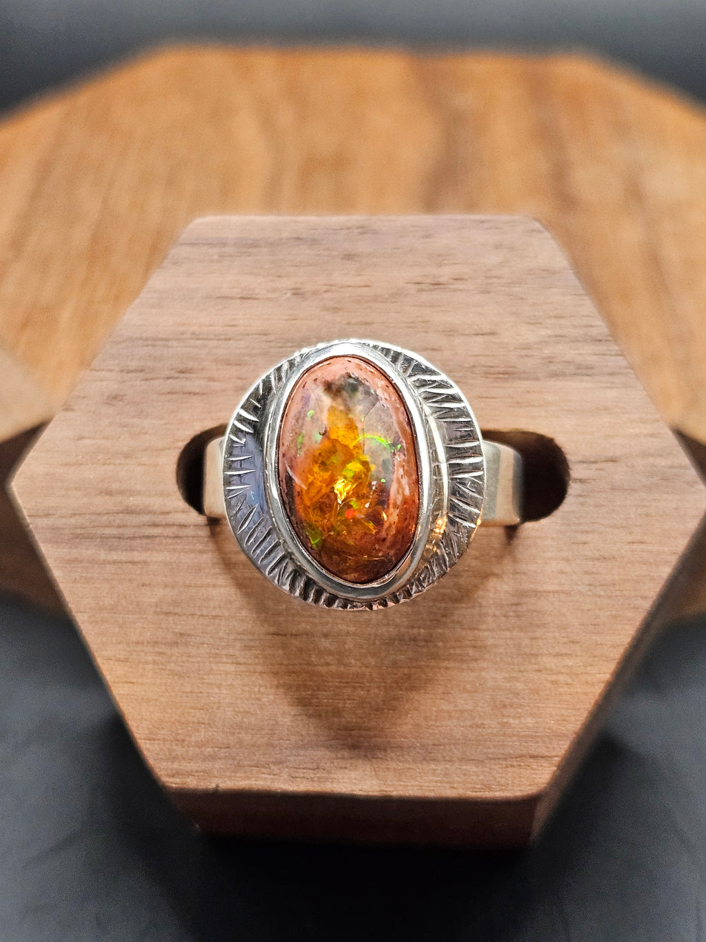 Oval shaped Mexican Matrix Opal featuring a fiery orange and yellow internal inlay with a textured background set in sterling silver. Size 7.25
