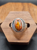 Oval shaped Mexican Matrix Opal featuring a fiery orange and yellow internal inlay with a textured background set in sterling silver. Size 7.25