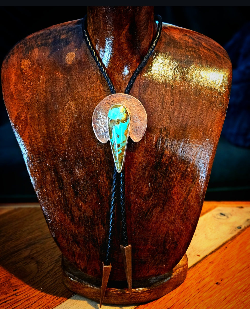 Royston Turquoise Bolo set in sterling silver with a hammered copper crescent shape backplate. Black leather cord with triangular copper tips 