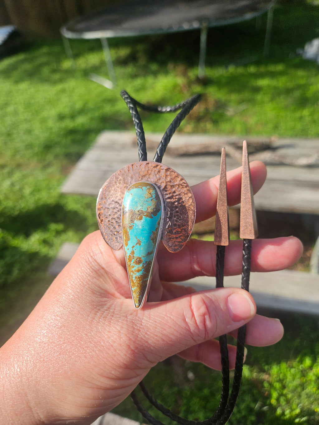Royston Turquoise Bolo with hammered Copper crescent backplate. Black leather cord with triangular copper tips.