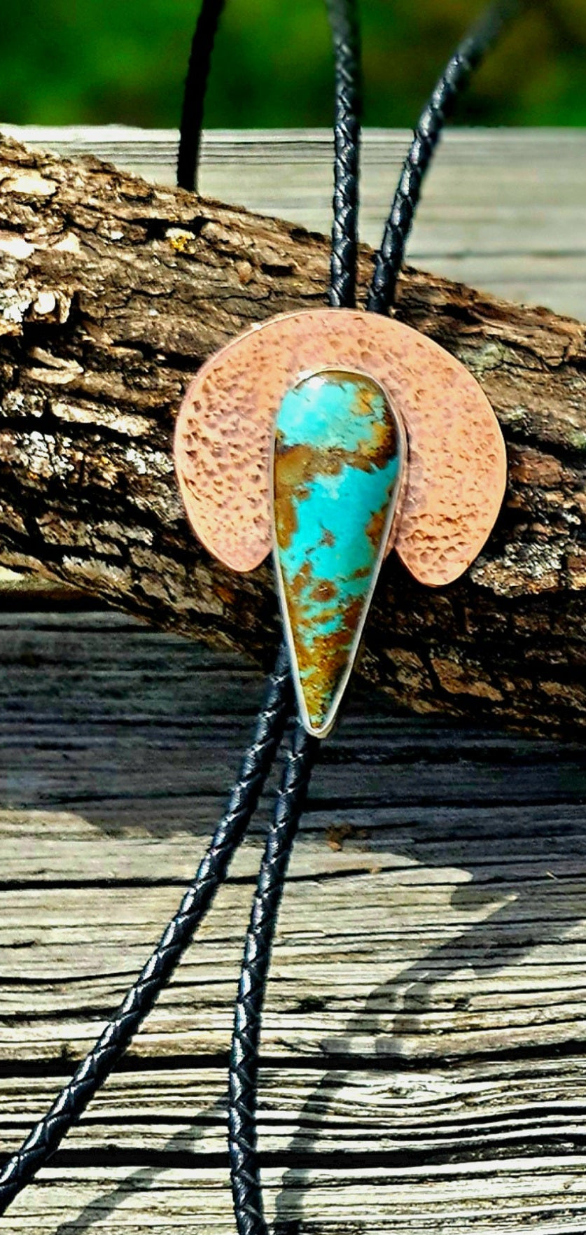 Teardrop shaped Royston Turquoise set on a crescent shape hammered copper backplate 