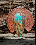 Teardrop shaped Royston Turquoise set on a crescent shaped hammered copper backplate.