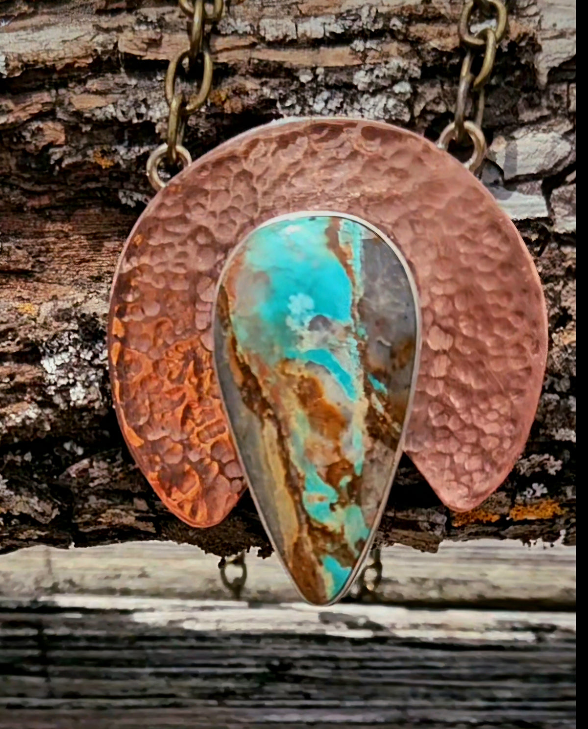 Teardrop shaped Royston Turquoise set on a crescent shaped hammered copper backplate.