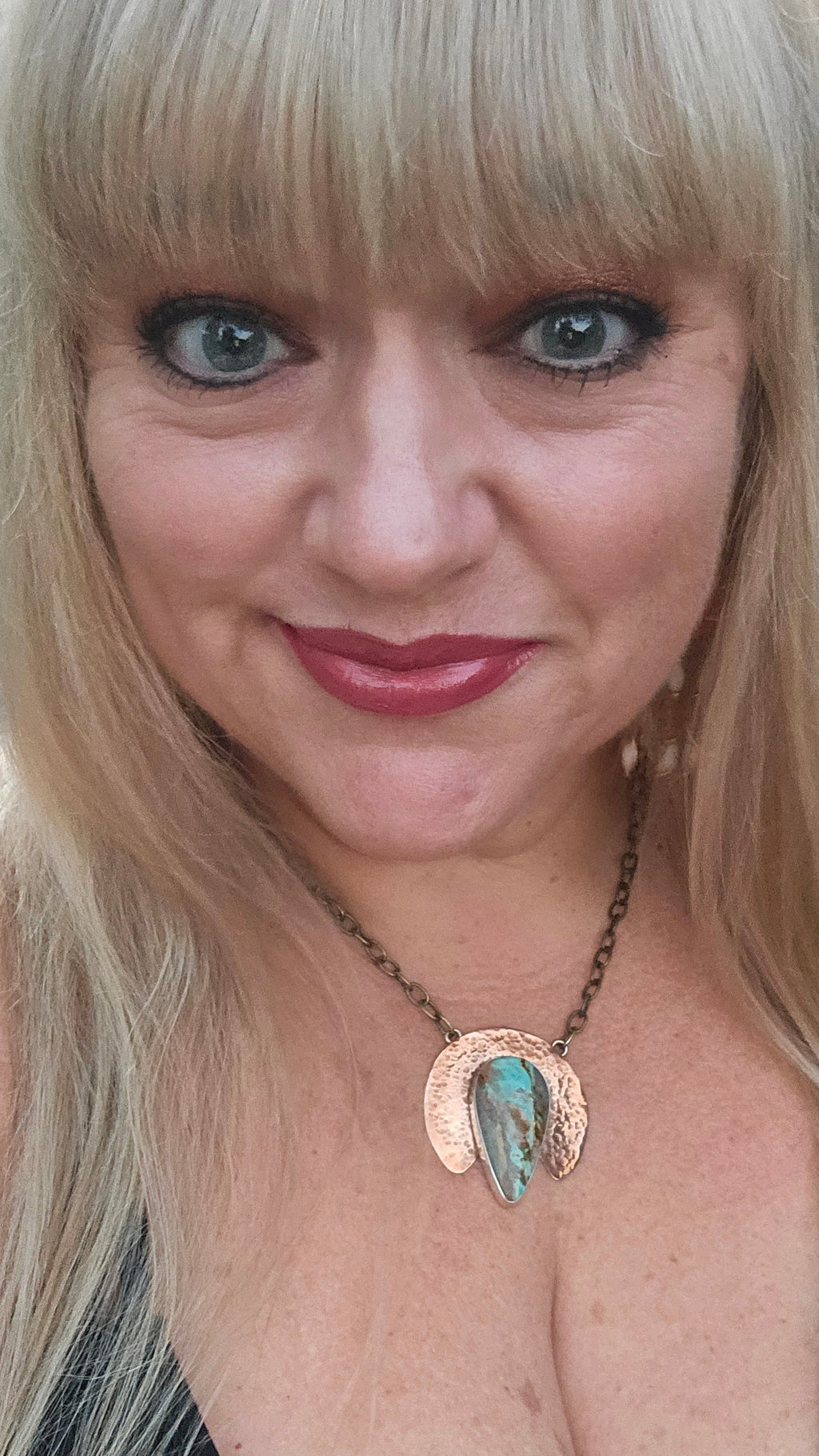 Royston Turquoise Pendant with a hammered copper half moon backplate. Silver bezel and brass chain