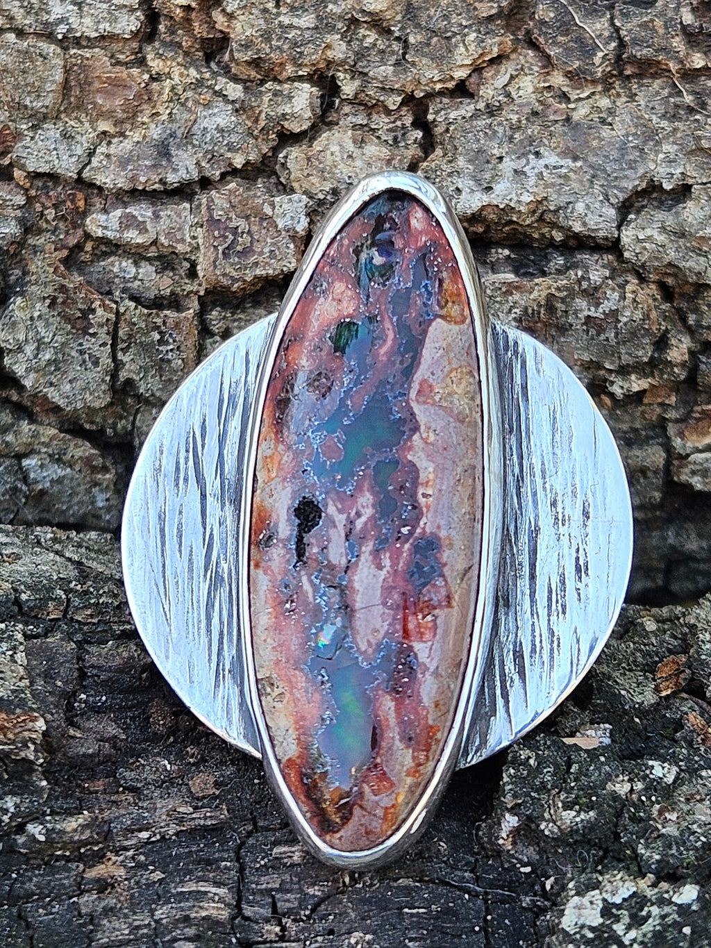 Large sterling silver disc ring with an oval shaped Mexican Matrix Opal set it the middle. 