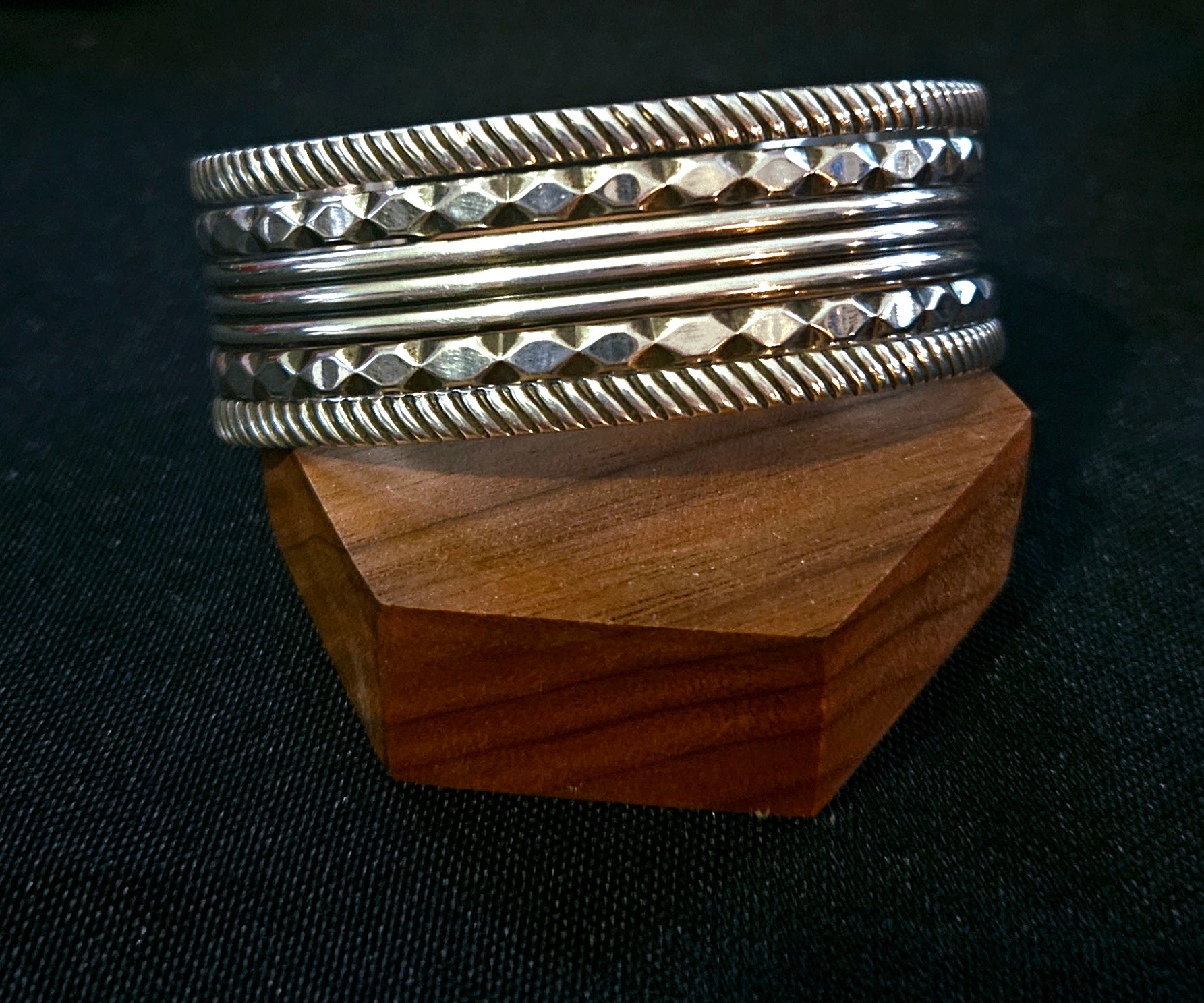 Sterling silver 5 band cuff bracelet with textured and faceted details. 