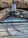 Rectangular sterling silver Biggs Jasper Bolo with black leather cord and copper triangular tips.