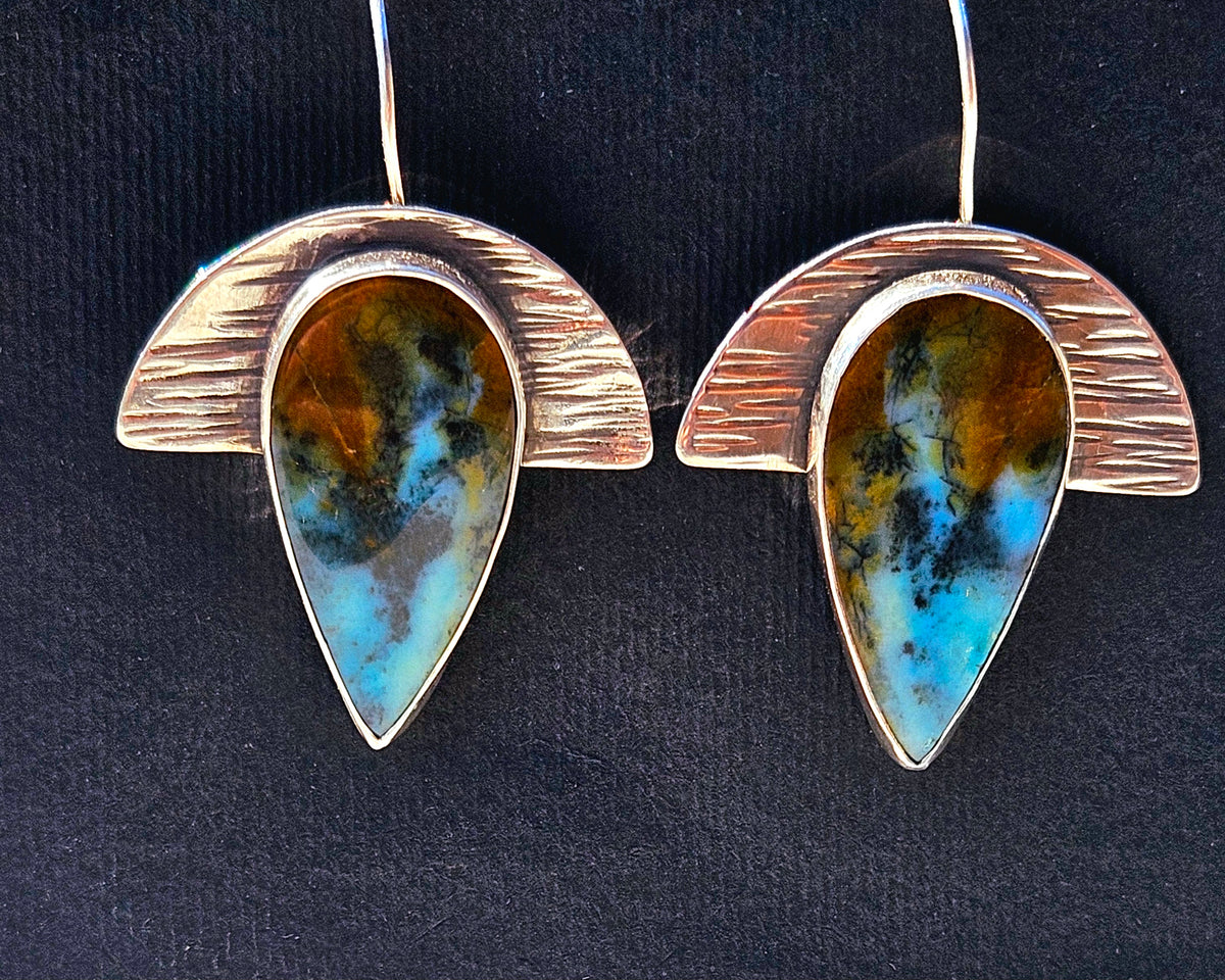 Geometric half moon textured silver earrings with teardrop blue opalized wood. Dangle- blue, brown, and black colors.