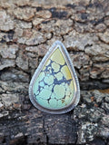 Teardrop Hubei Turquoise Ring set in sterling silver with a textured border. Ring band has 3 lines that are oxidized. Size 12