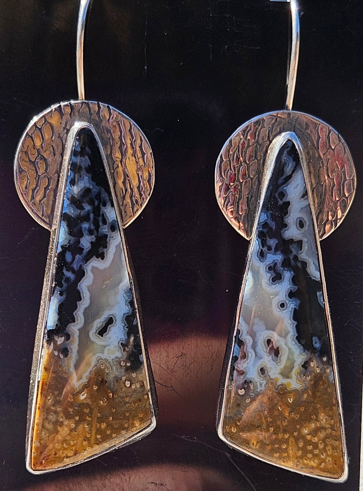Triangular Shaped Petrified Palm Wood Earrings set in sterling silver with a textured circular backplate. Dangle earrings. Multi color, black, white, and amber.