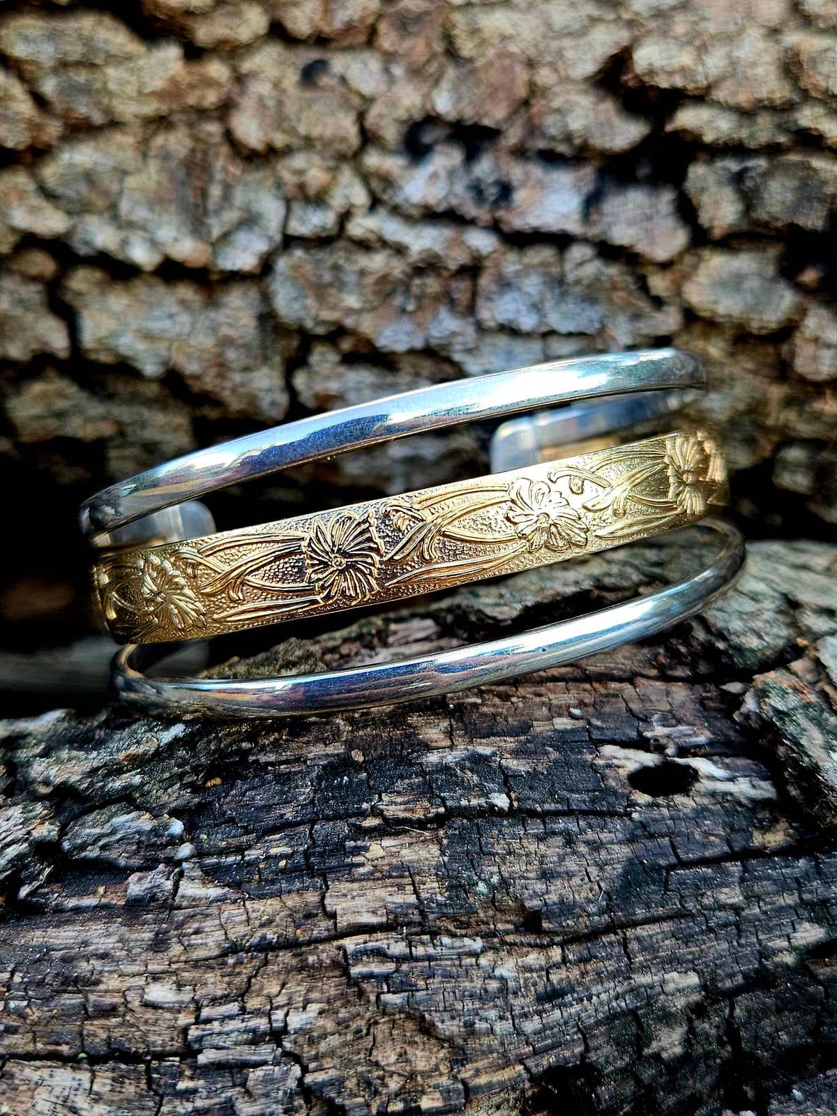 Triple Band Cuff with a wide 12k gold filled floral pattern wire band and 2 silver bands.