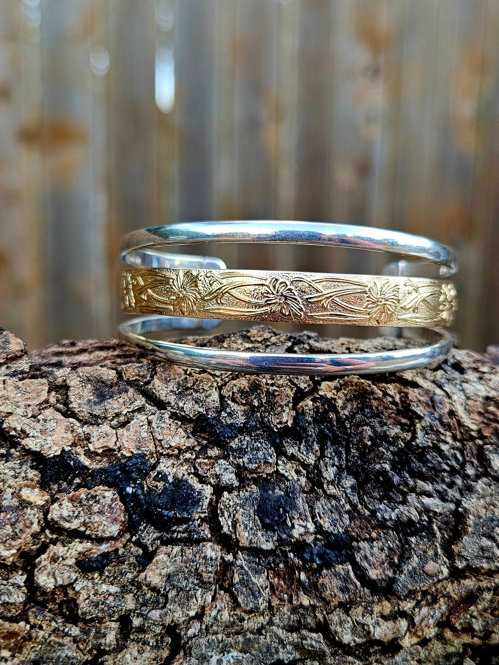 Triple Band Cuff with a wide 12k gold filled floral pattern wire band and 2 silver bands.