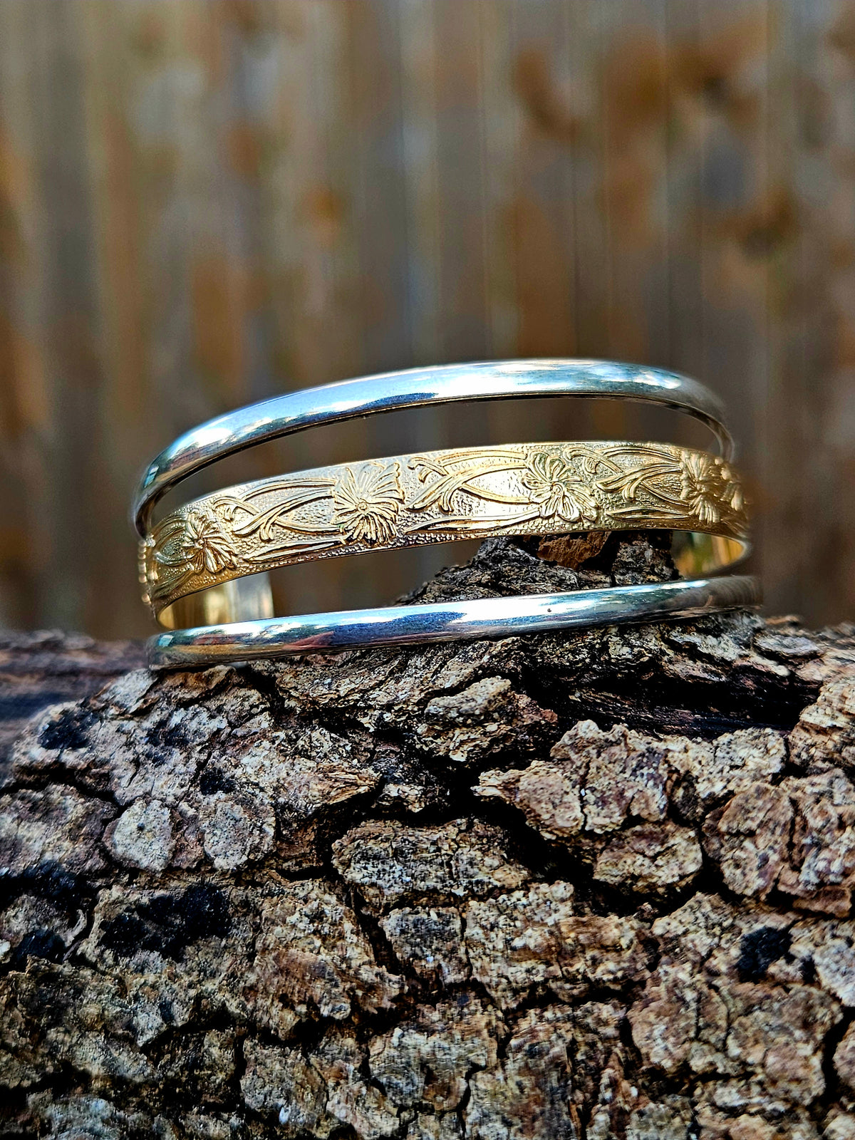 Triple Band Cuff with a wide 12k gold filled floral pattern wire band and 2 silver bands.